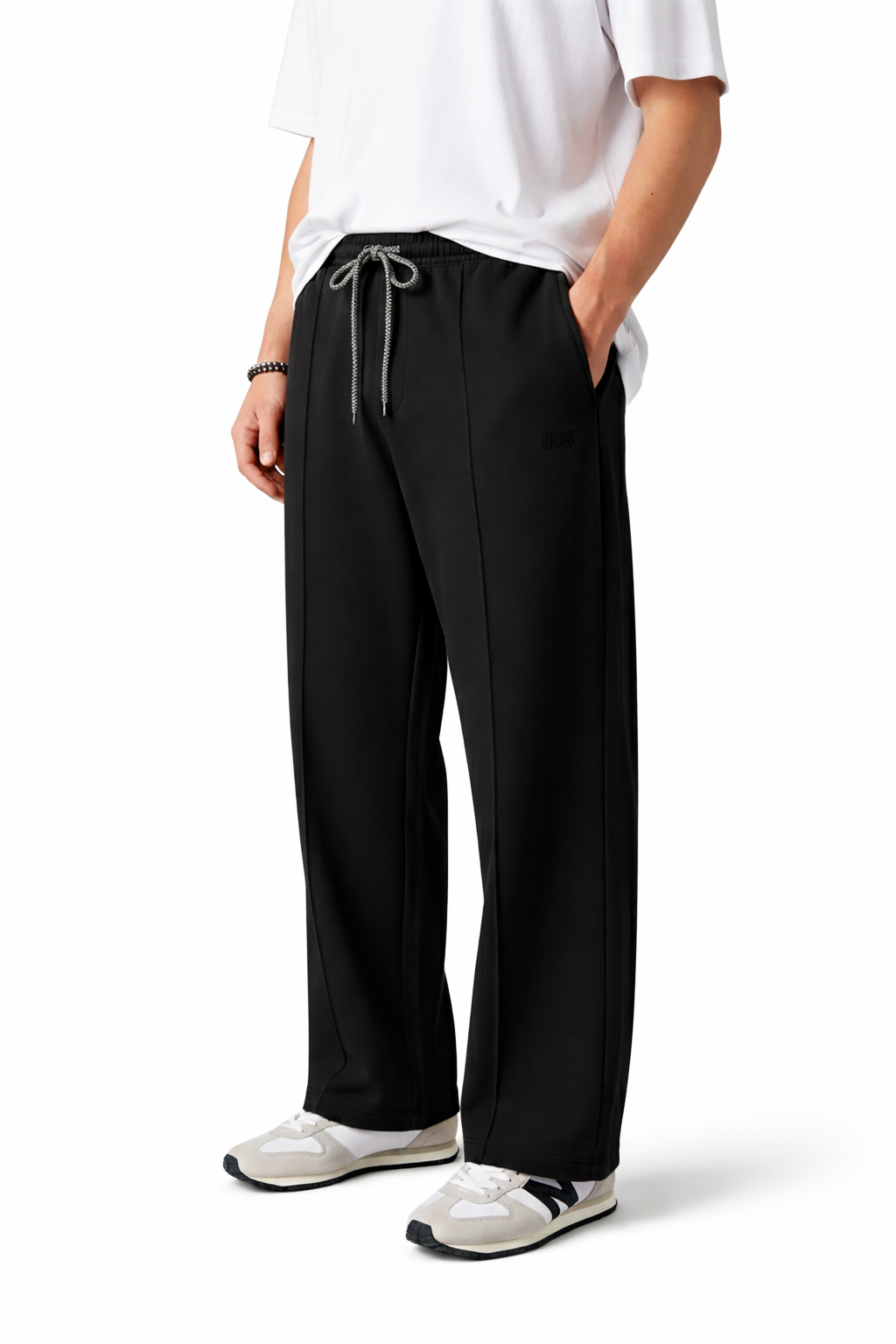 Person wearing black pants with a white shirt on a white background